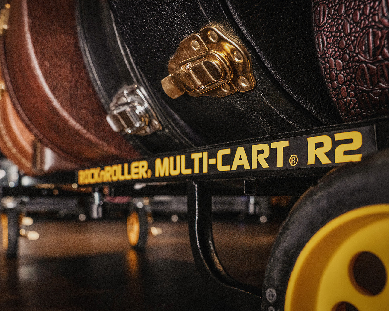 A lifestyle RockNRoller® Multi-Cart® R2RT "Micro" carrying musical instruments, brand-focused.